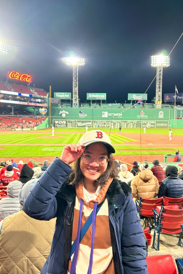 Cheering at Boston Red Sox baseball game, soaking in local life and sport spirit beyond the classroom. 