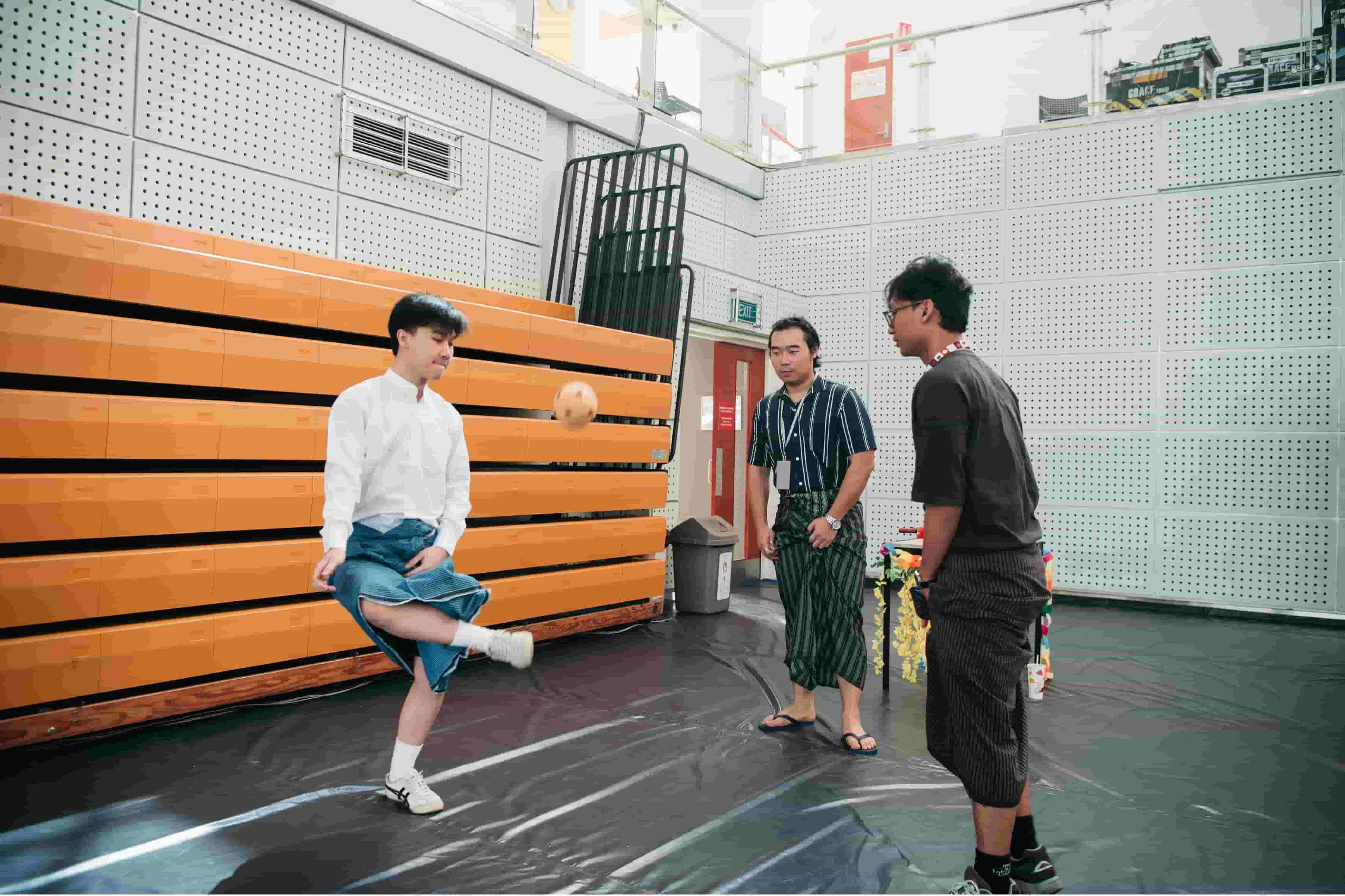 Students passionately played Chinlone, the ancient Myanmar sport, while wearing traditional longyi.