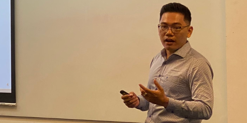 Photo of a lecturer teaching in front of a white board showing the general corporate information of Sabeco to a group of postgraduate students