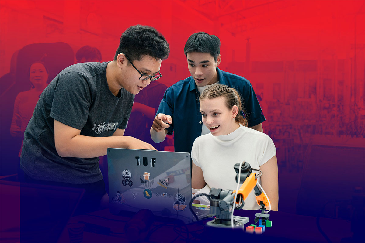 Three students looking at the laptop screen