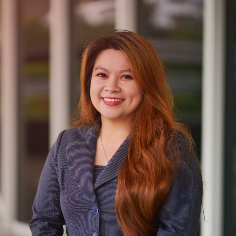A girl wearing a blazer and smiling