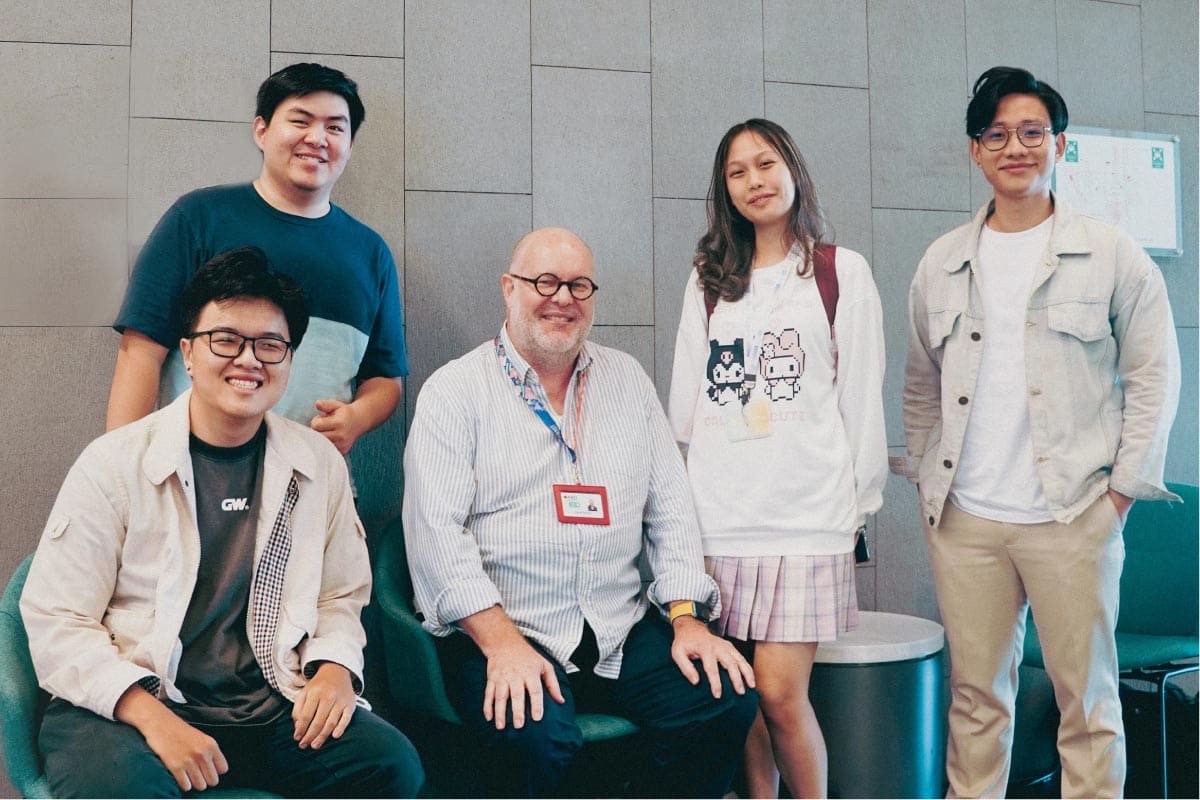 Photo of one professor and four RMIT Vietnam students posing together at the RMIT Vietnam campus.
