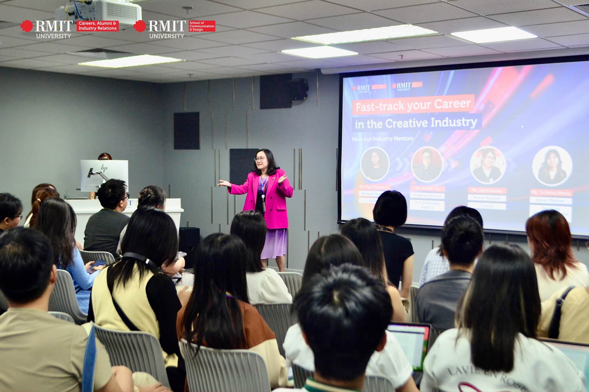 Audience seated in a classroom listening to a presentation