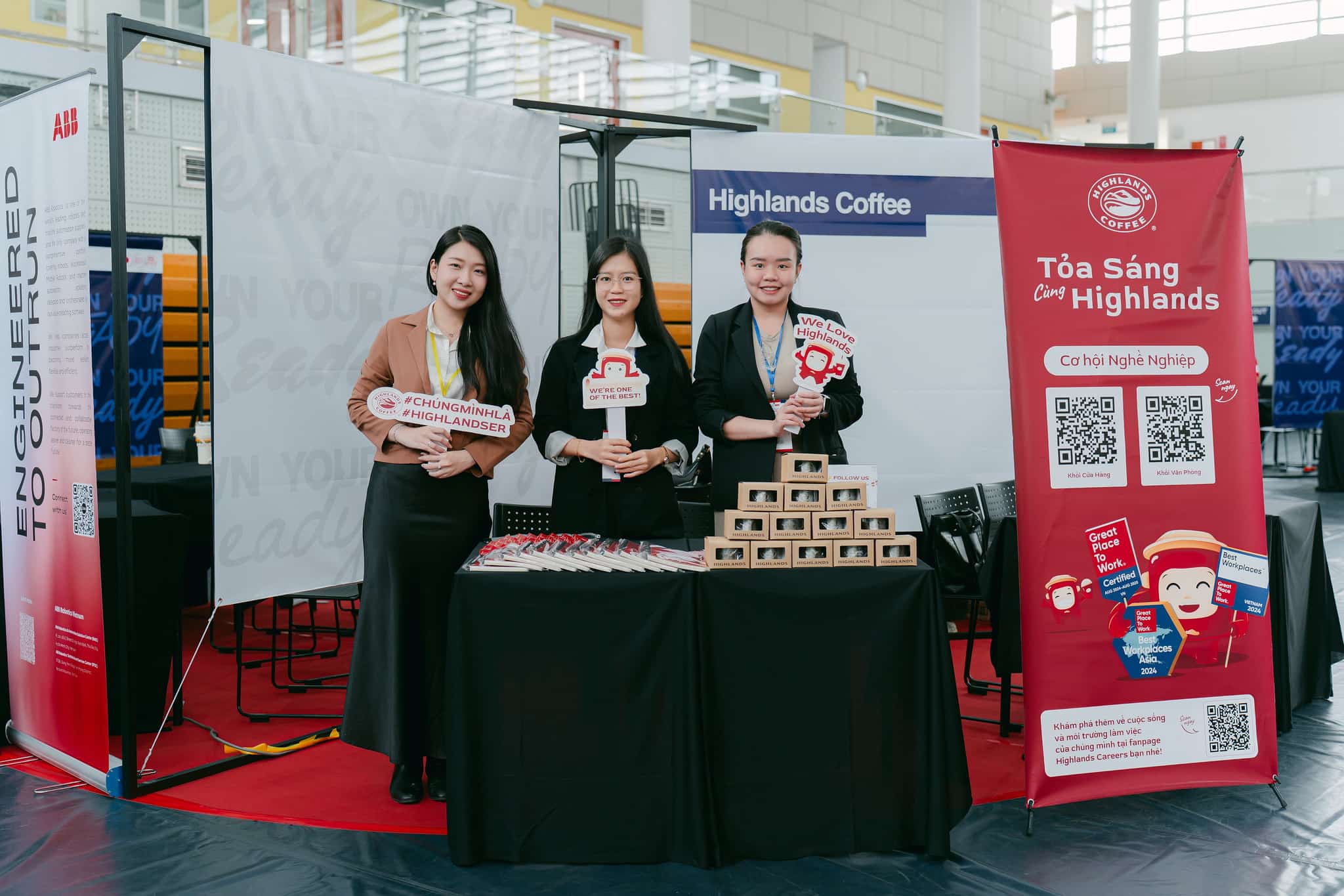 Three women standing in an event booth