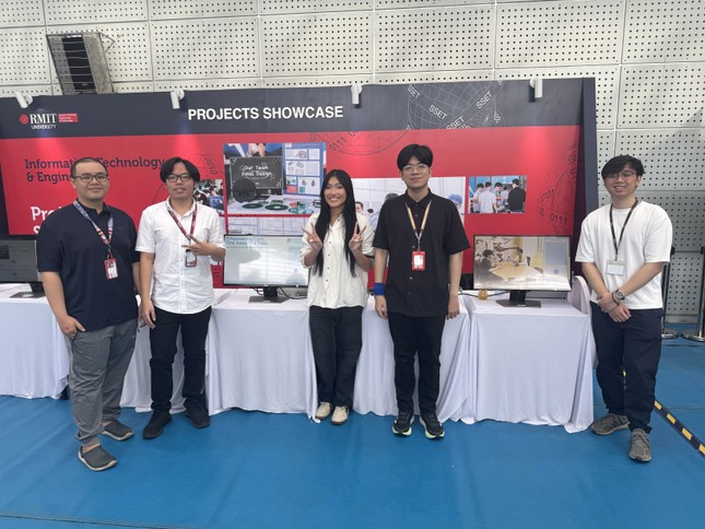 Photo of a group of five RMIT students showcasing their project as part of the School of Science, Engineering & Information Technology program