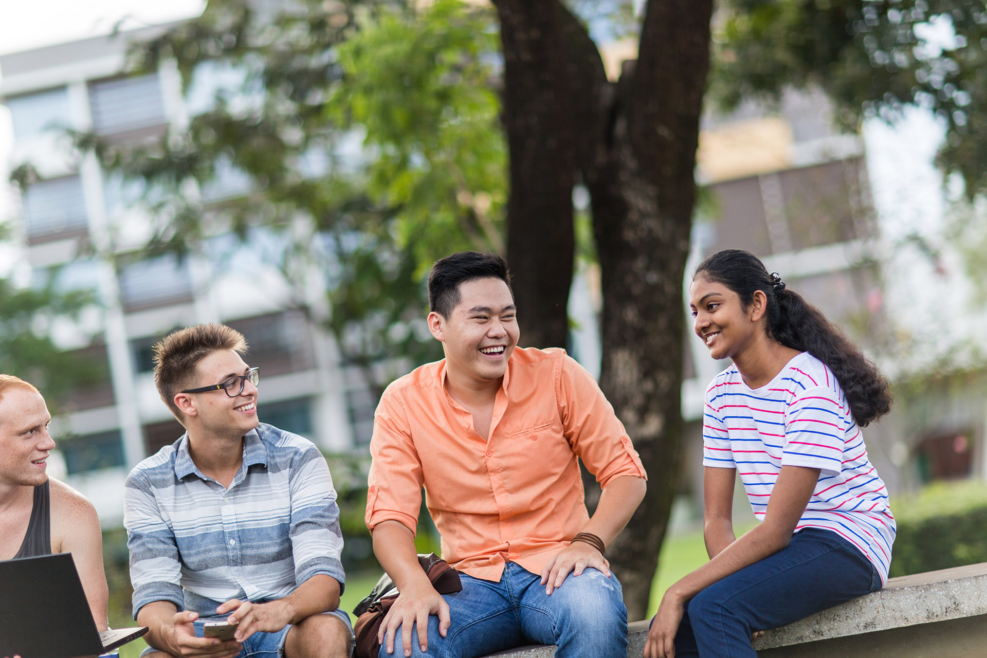 A group international students sitting together smiling