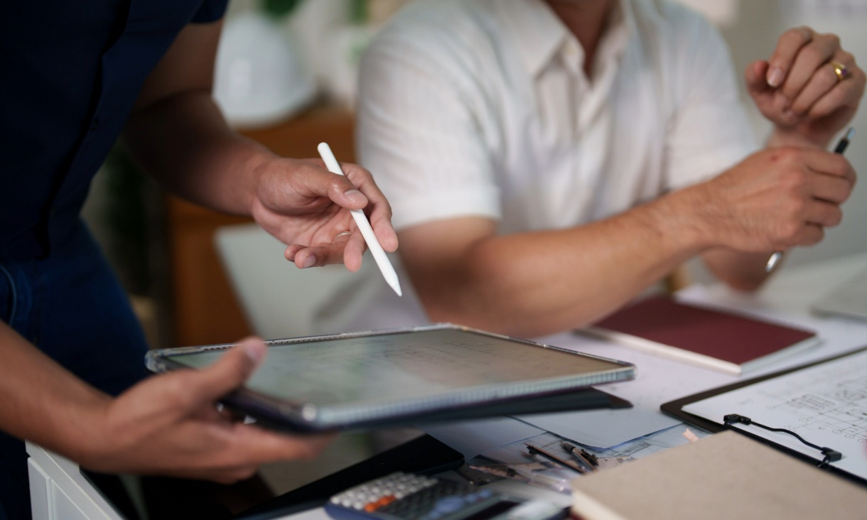 A close-up shot of a man using a tablet
