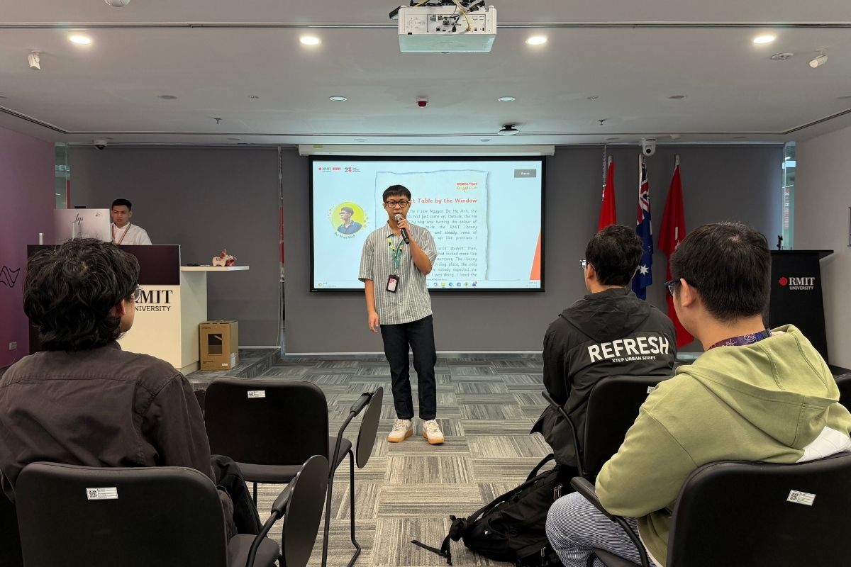 The photo showing a male student giving speech in front of a classroom