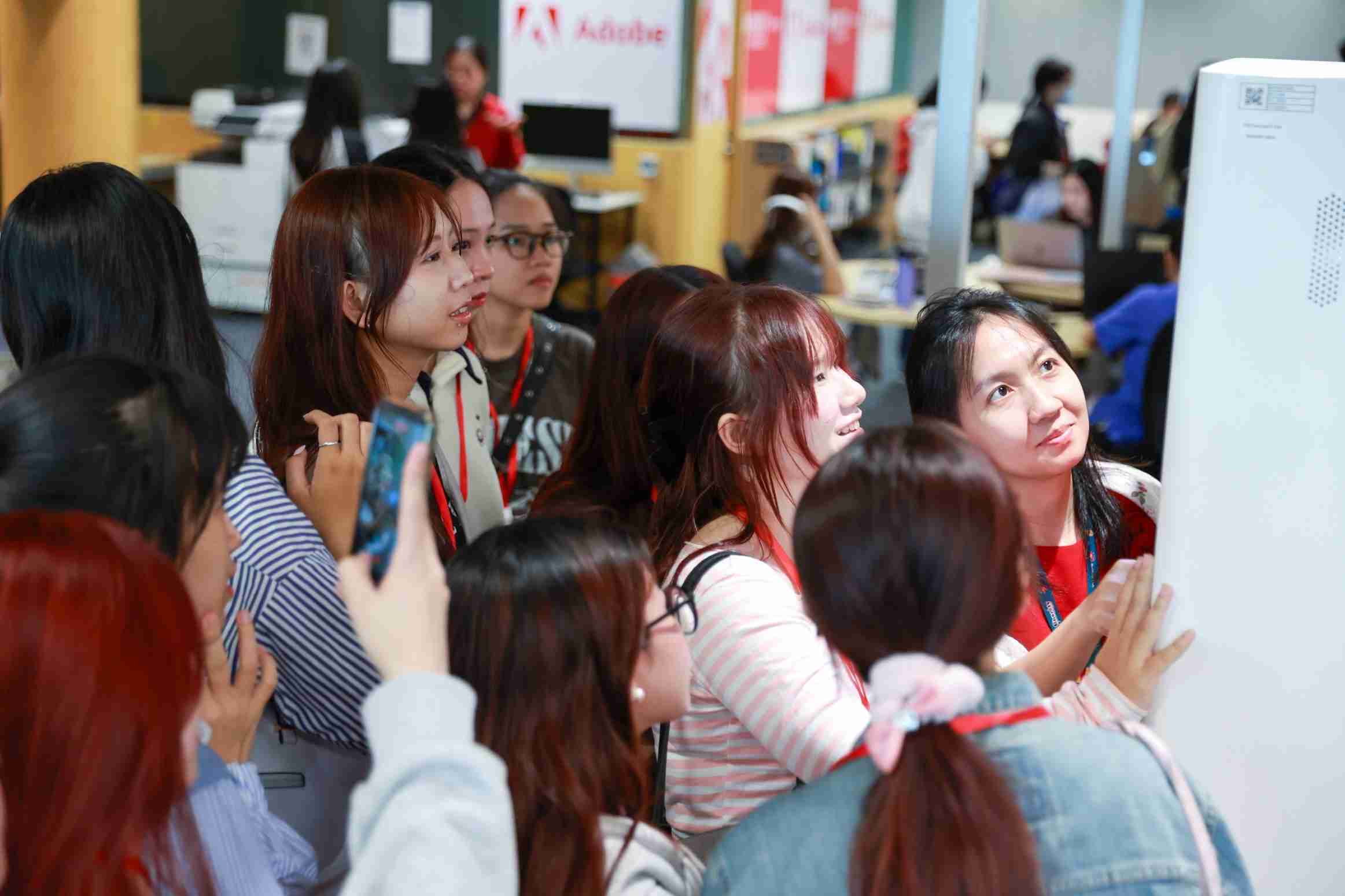 photo of a group of people gathering in front of a machine