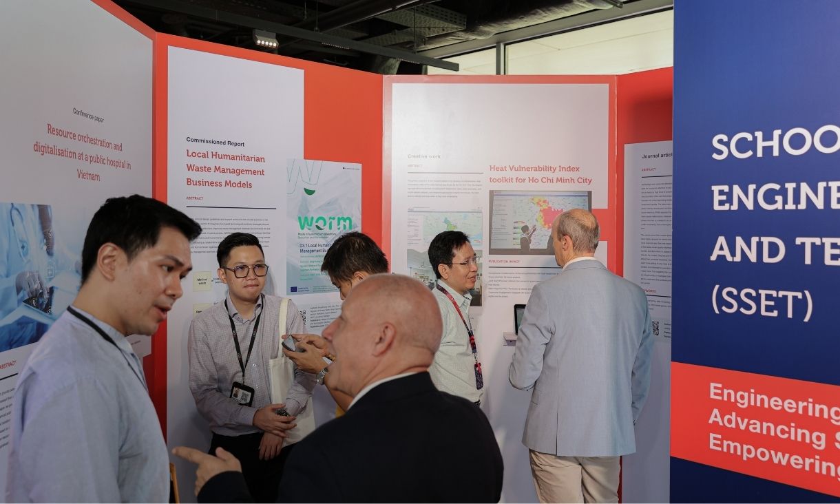 The photo of a group of men, dressing formally, contemplating an exhibition and talking to each other.