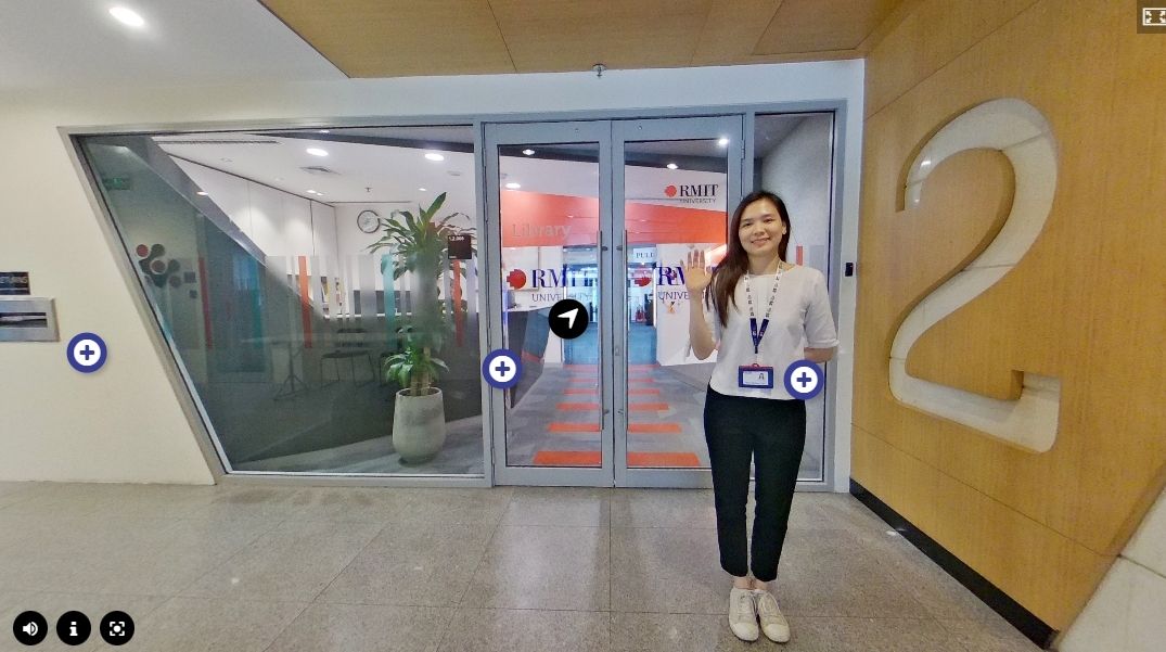 The photo is about a girl standing in front of a building entrance, she is smiling and waving her hands friendly