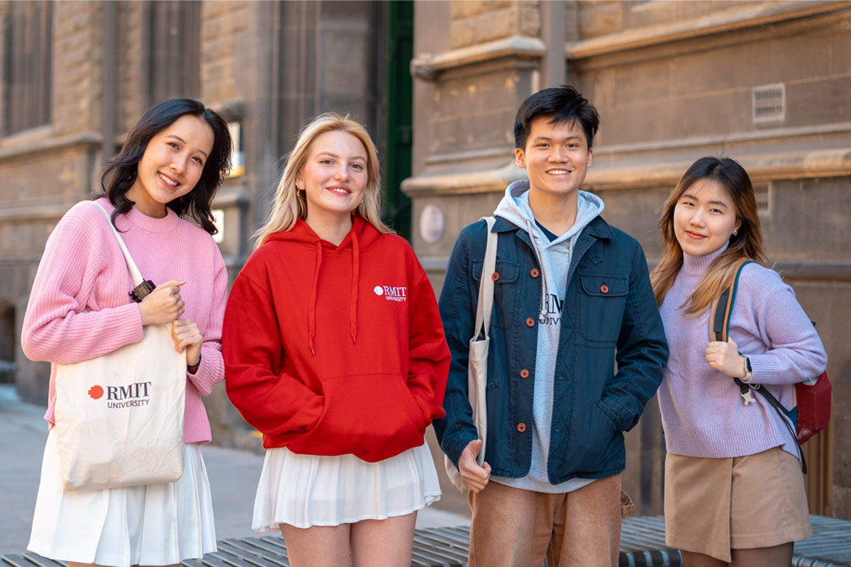 a group of students posing in front of a building 