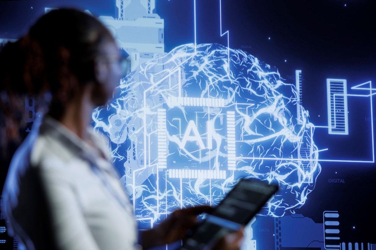 Woman looking at a background depicting a digital brain and AI