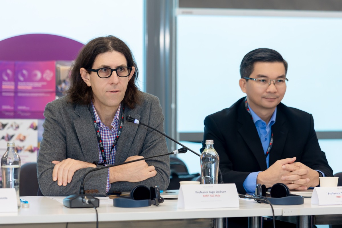 Two men sitting next to each other