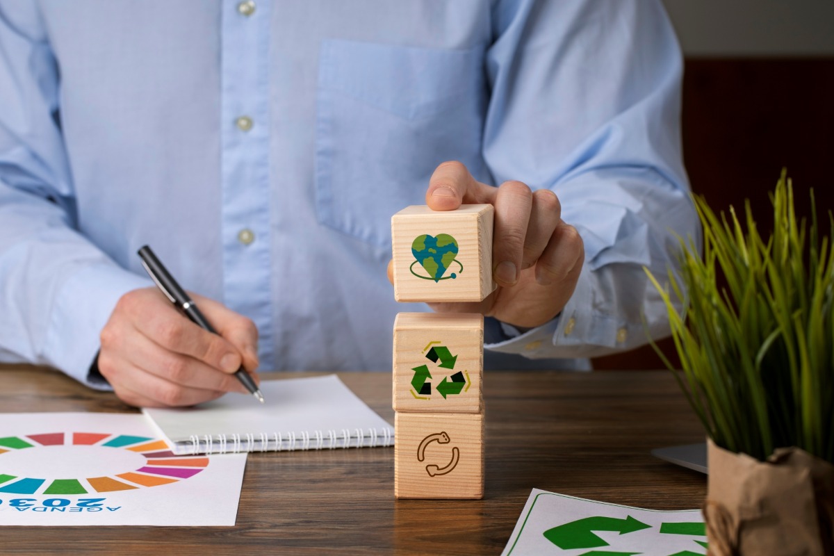 Man with wooden blocks depicting circular economy