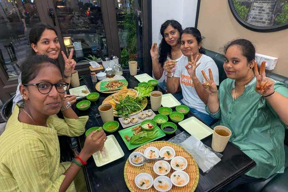 five students pose for a photo at dinner