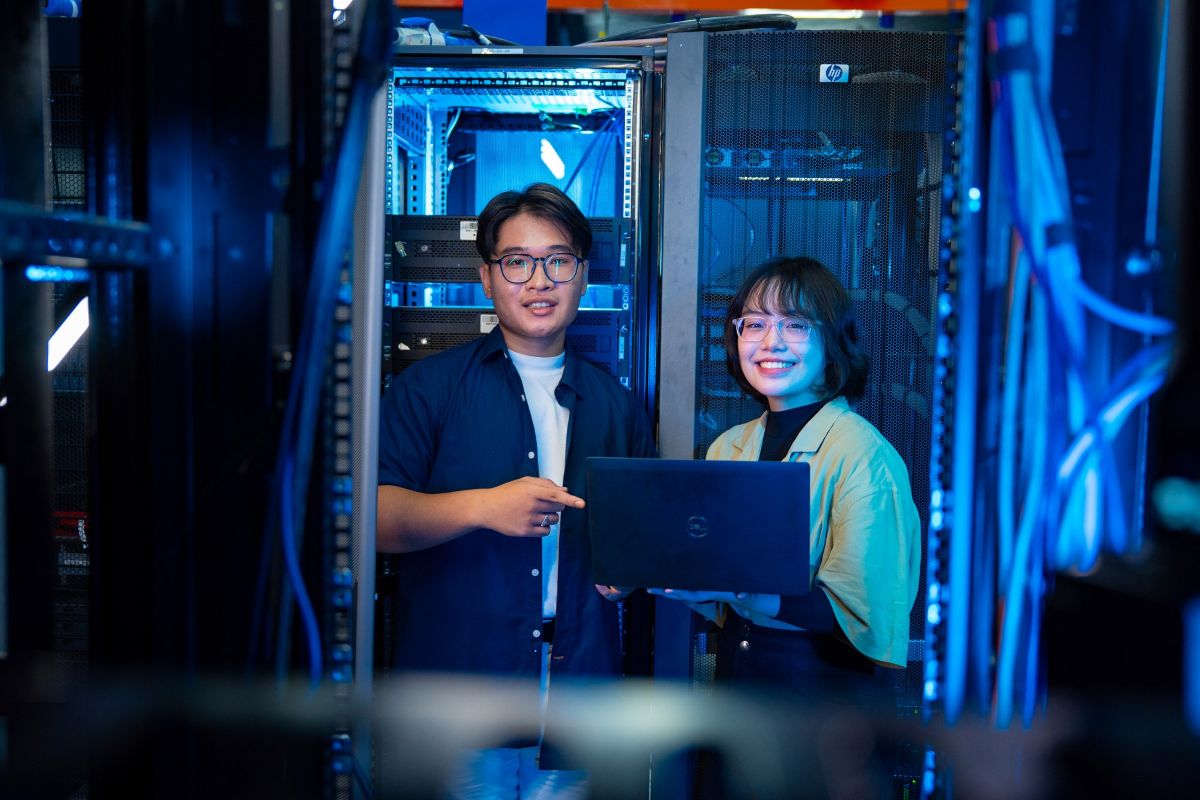 Two students standing in a server room