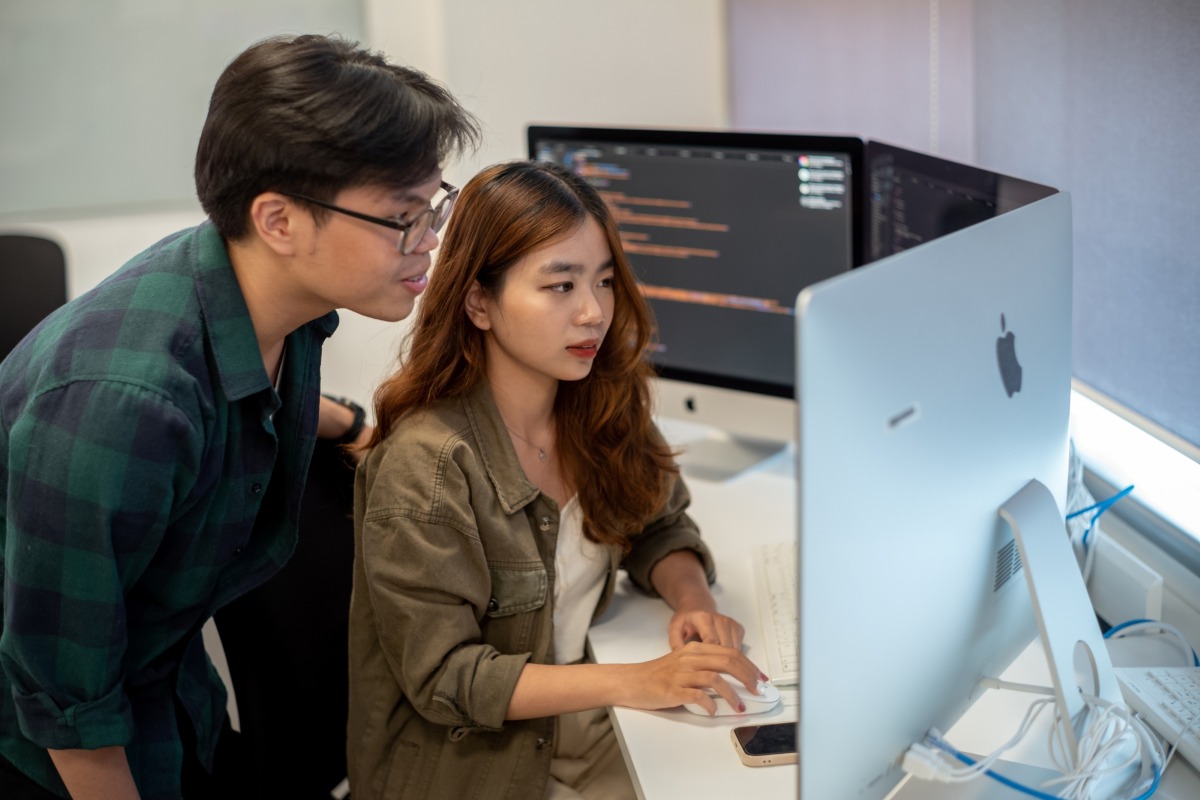 Two students looking at a computer