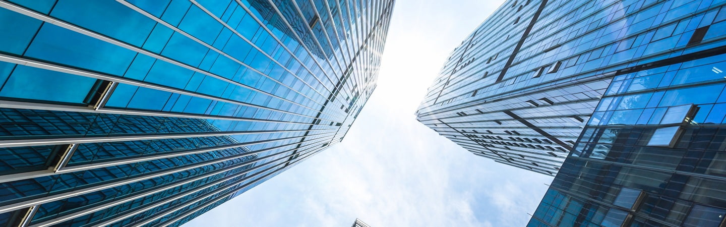View from the ground towards two skyscrapers