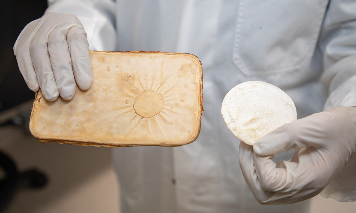 RMIT researcher Nattanan Chulikavit shows off the compressed mycelium sheets she created for the project.