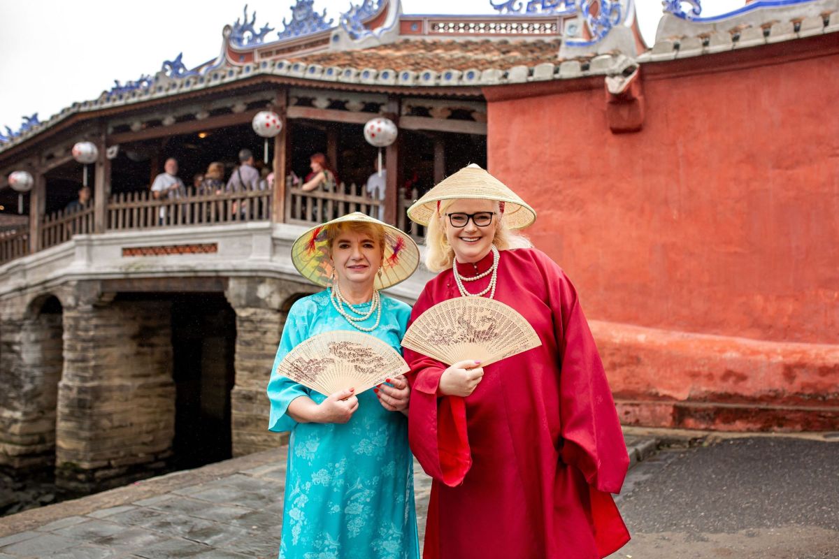 Two Western tourists dressed in ao dai in Hoi An