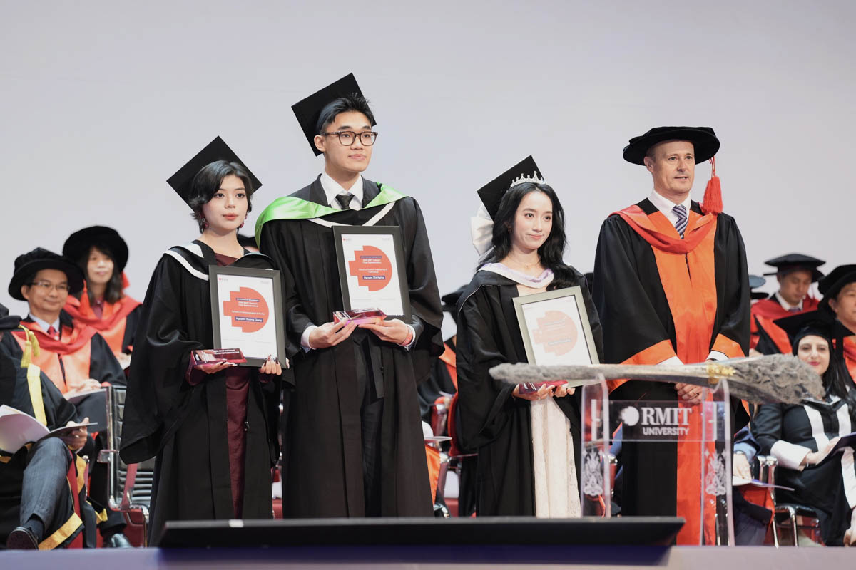 four people standing on stage
