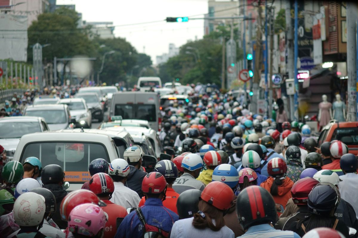Motorbikes and cars waiting in traffic
