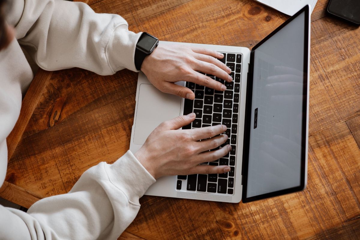 Human typing on a laptop