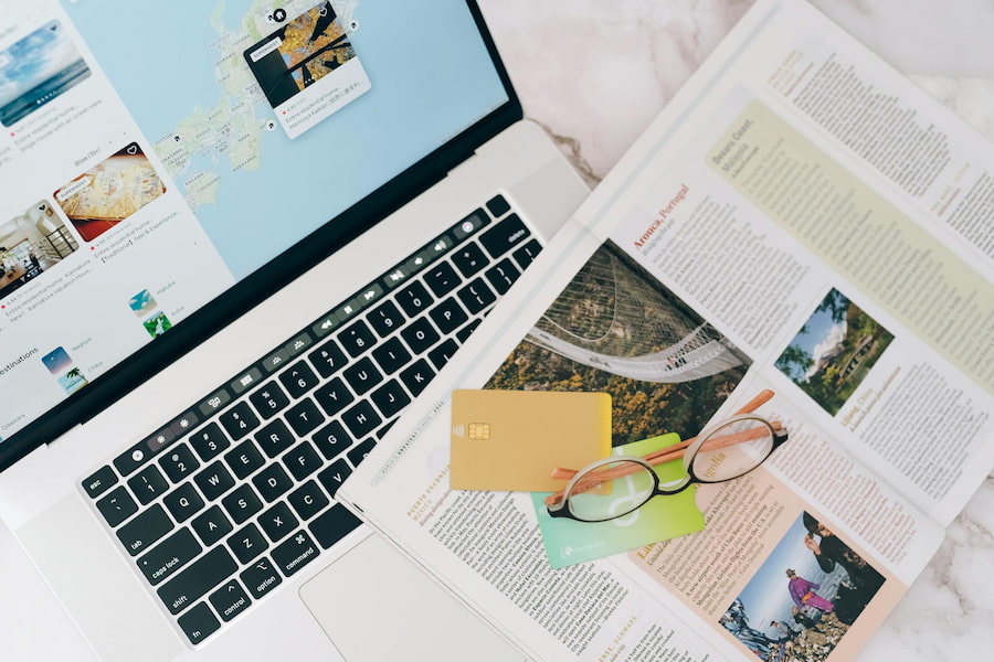 Laptop and travel magazine for trip planning