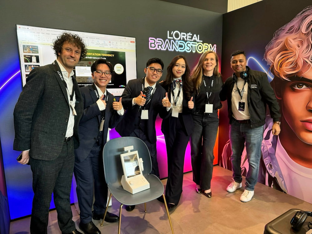 RMIT Vietnam students with organisers at the L’Oréal Brandstorm competition in London.