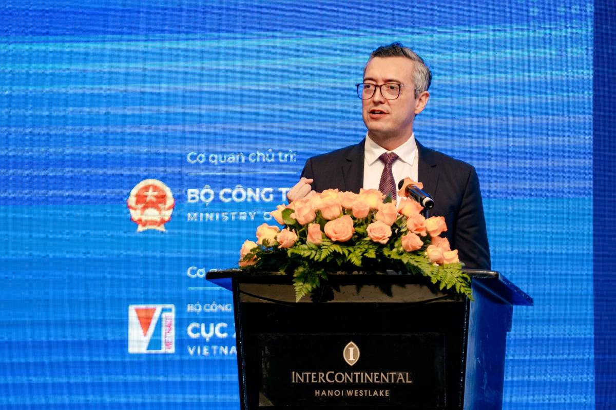 Santiago speaking at a lectern