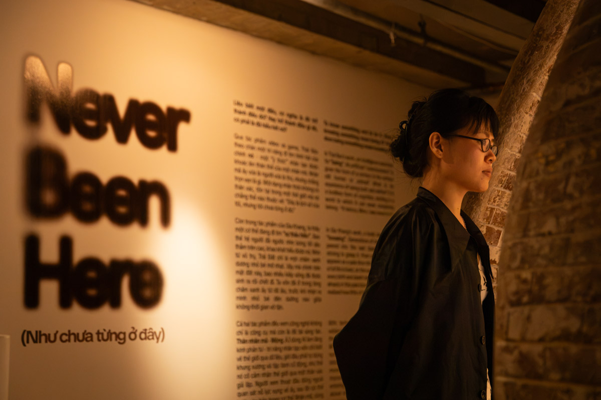 A woman standing in front of the exhibition description
