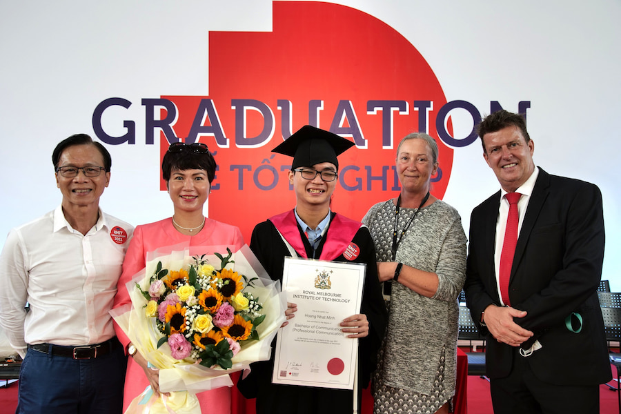 Minh with parents and RMIT staff at his graduation