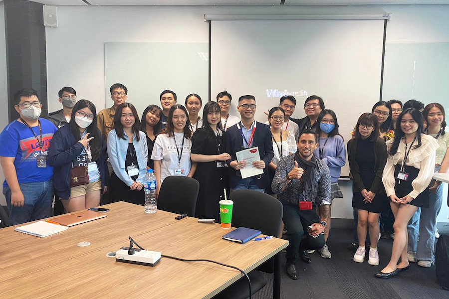 Minh poses with RMIT students and staff