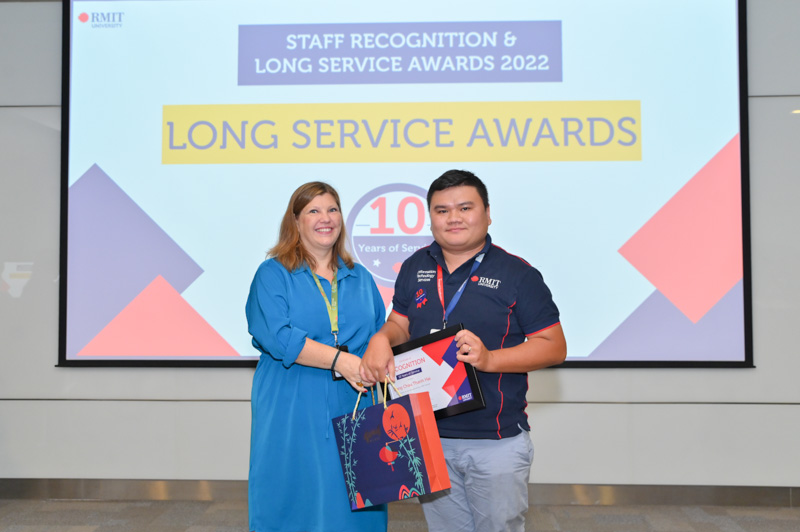 Director of Human Resources Ms Annie Gale giving a Long Service Award to Mr Dang Chau Thanh Hai from the Operations portfolio.