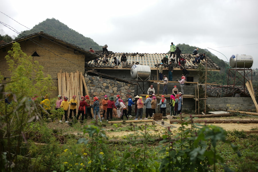 People building a house in a mountainous area