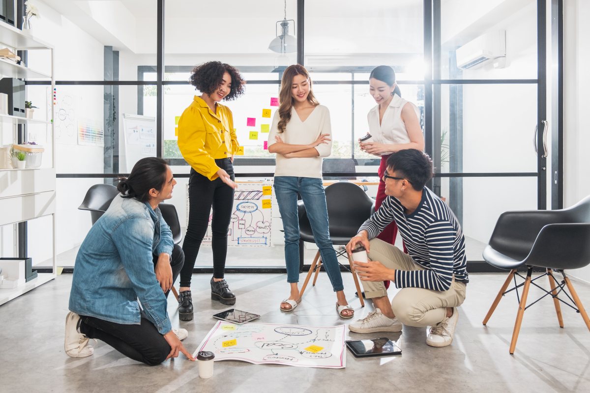 Five young people discussing business idea