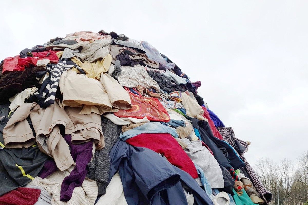 a high pile of discarded clothes
