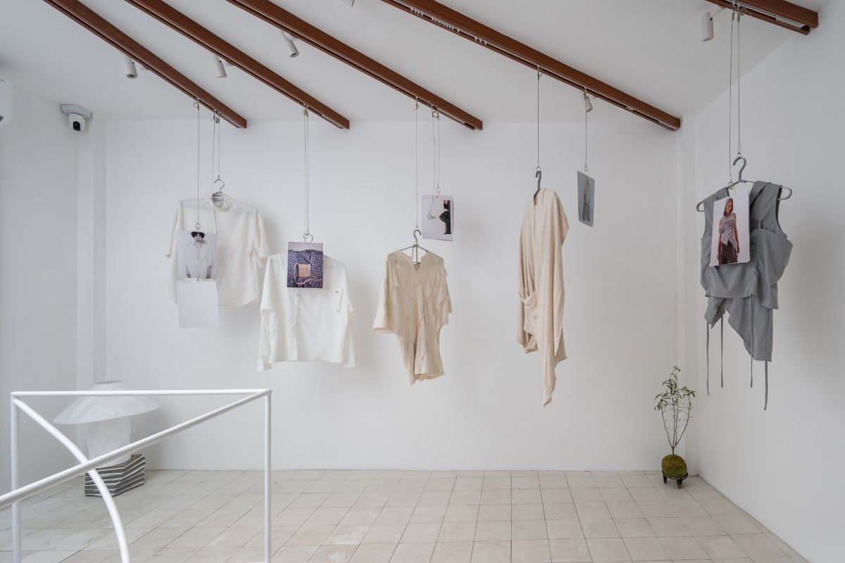 Five pieces of clothing hanging from the ceiling