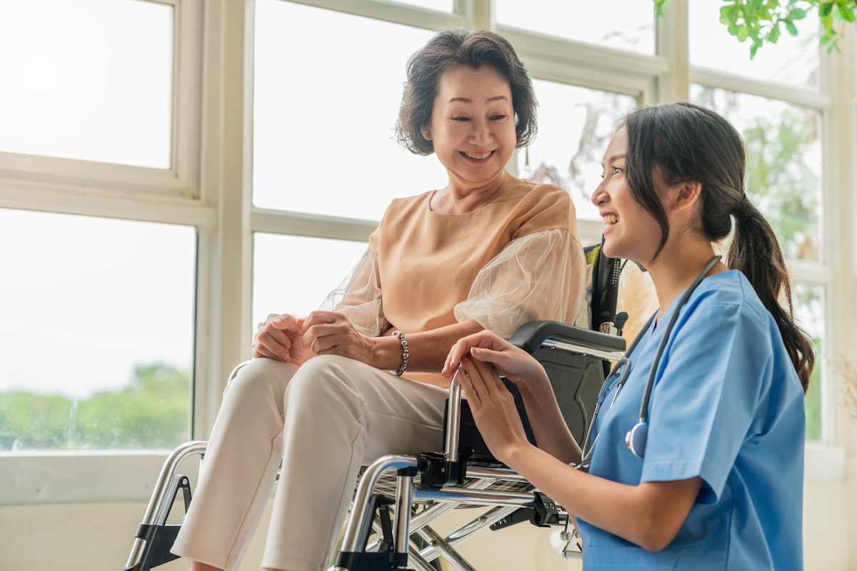 thumbnail-asian-young-caregiver-caring-her-elderly-patient-senior-daycare-handicap-patient-wheelchair-hospital-talking-friendly-nurse-looking-cheerful-nurse-wheeling-senior-patient.jpg