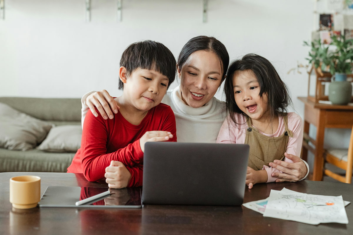 thumbnail-mother-and-two-children-using-laptop-at-home.jpg