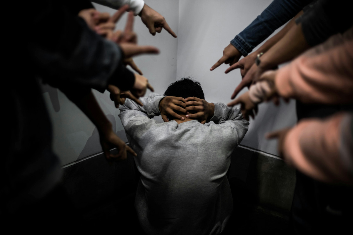 thumbnail-person-cornered-by-accusing-hands-dark-room-child-abuse-cases-pyschology-rmit-vietnam.jpg