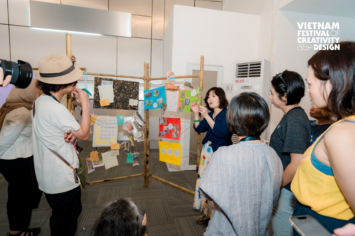 Group of people listening to a presenter at a booth