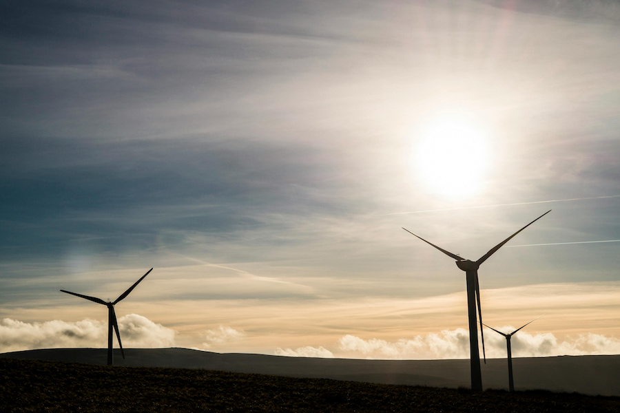 wind turbines under a bright sun
