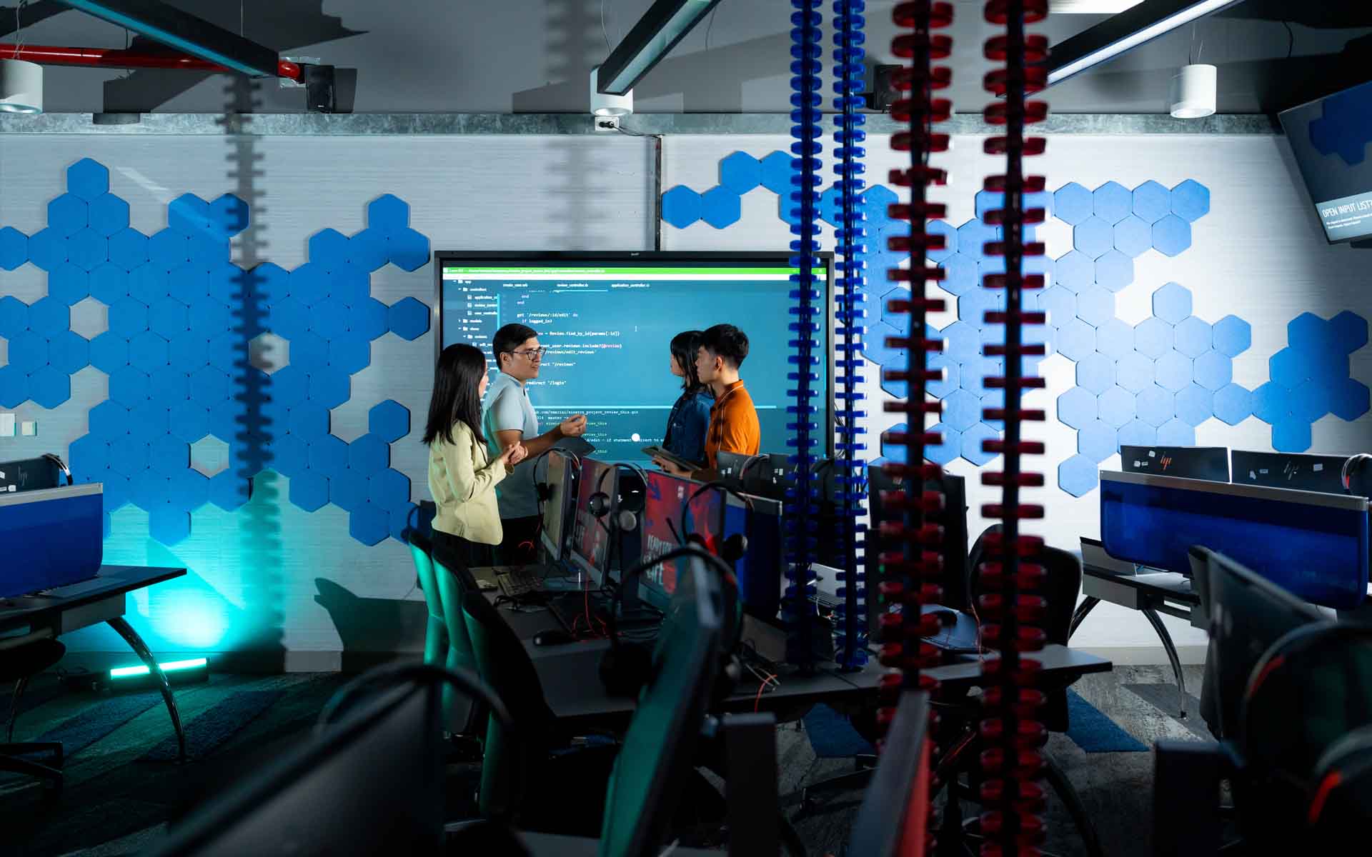 a group of post graduate students working in a computer room