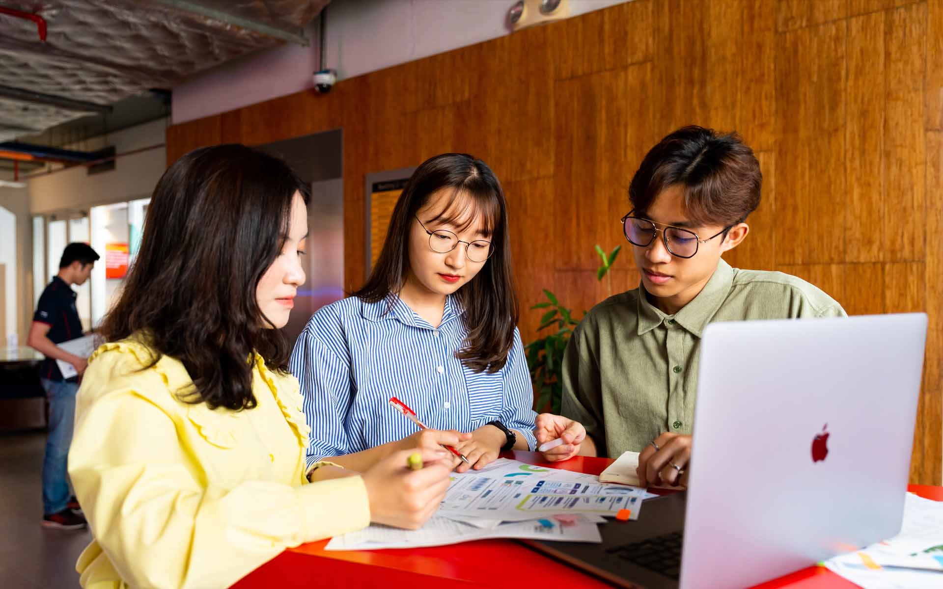 three students working in campus