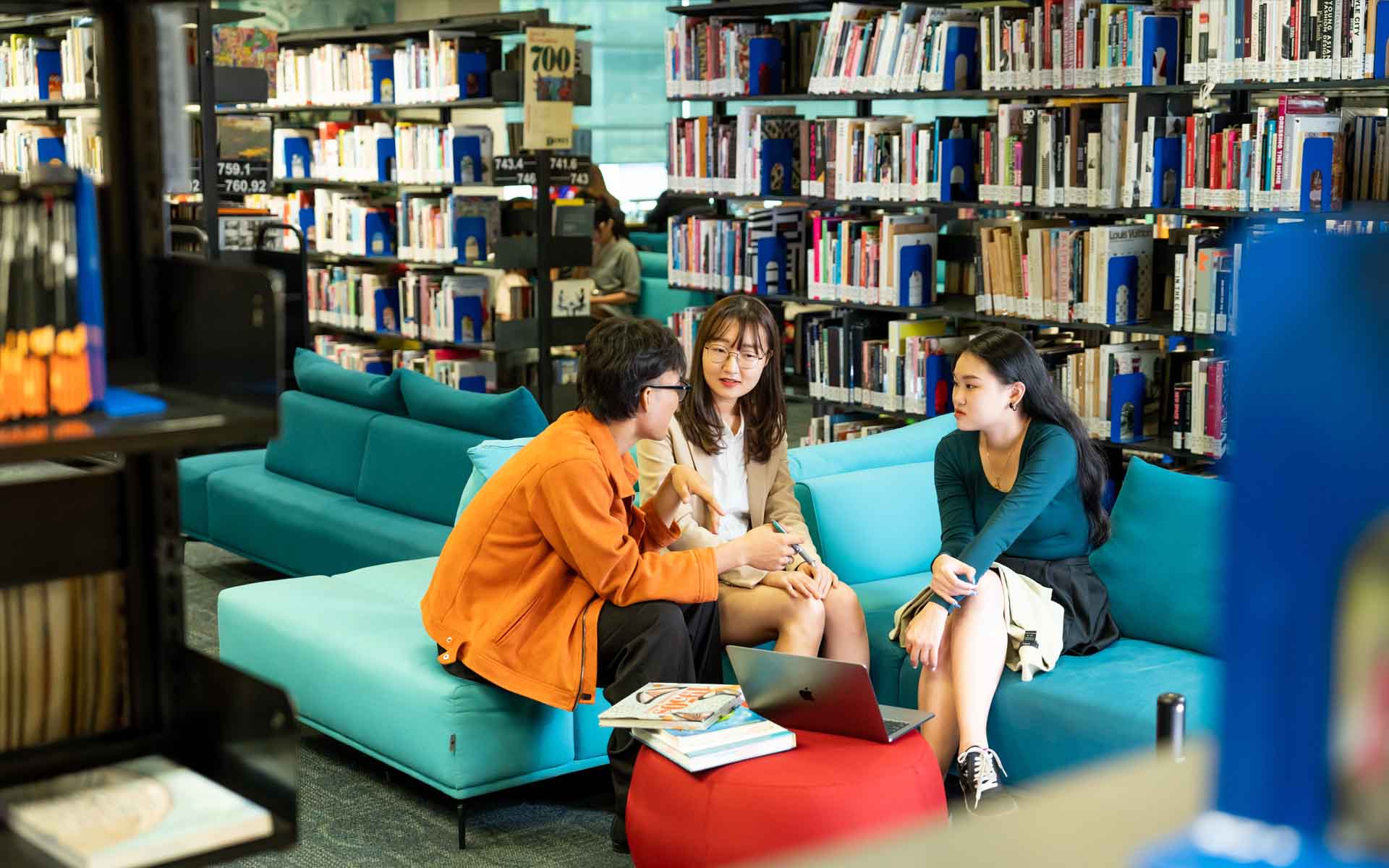 a group of students having a discussion in a library