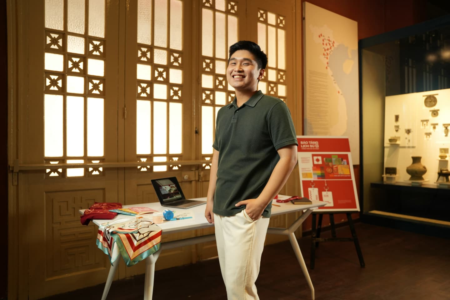Pham Quang Vinh standing among his team’s creative work for Ho Chi Minh City History Museum