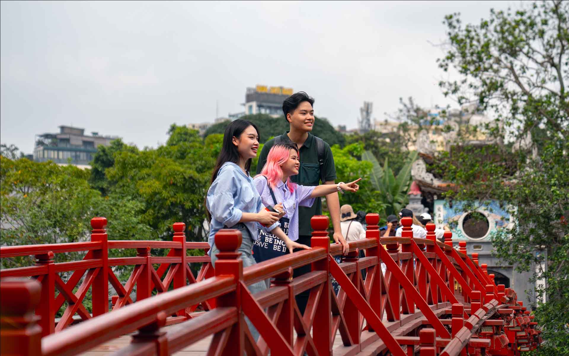 three students engaged in outdoor activities in HN 