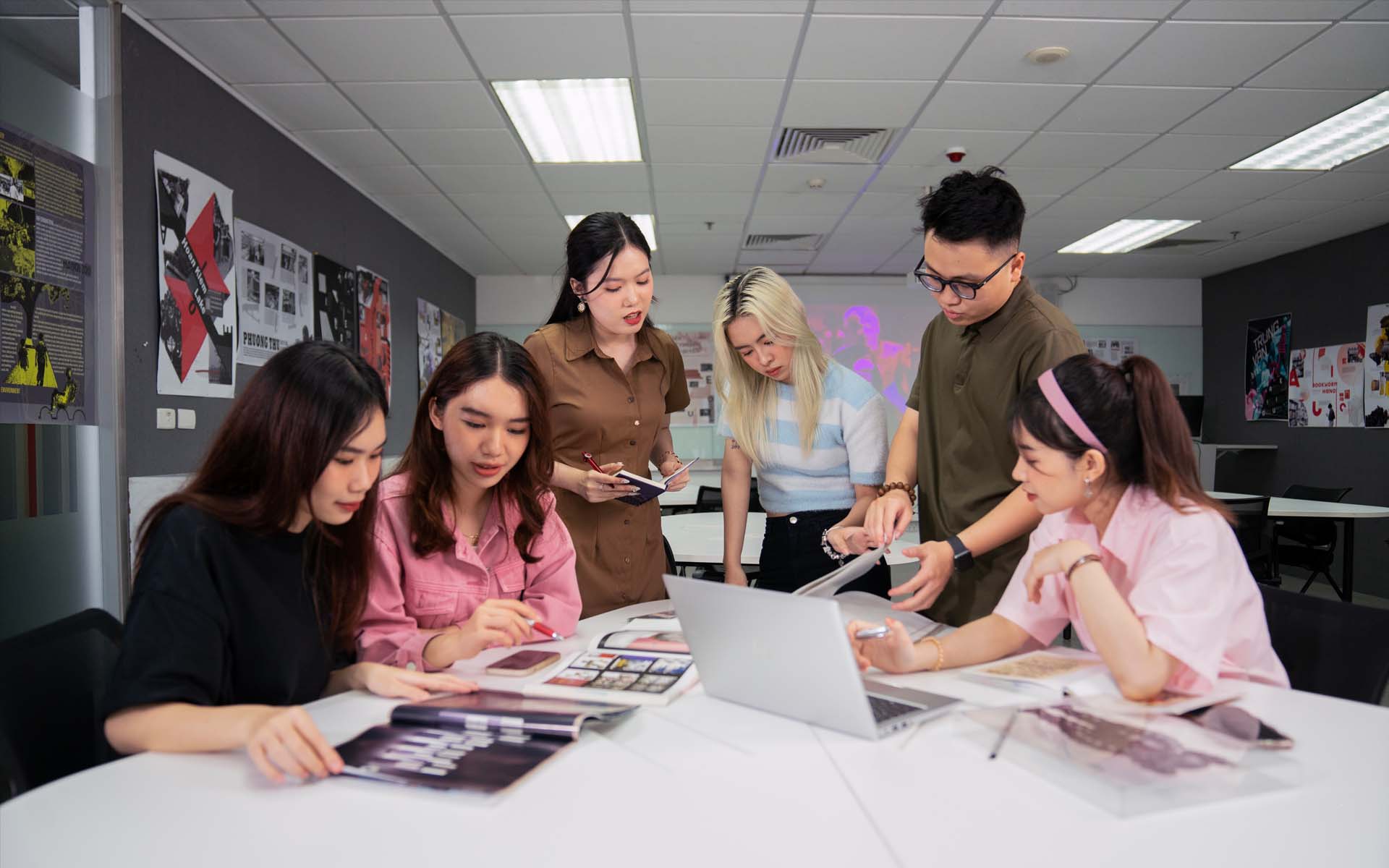 a group of students working in a fashion class